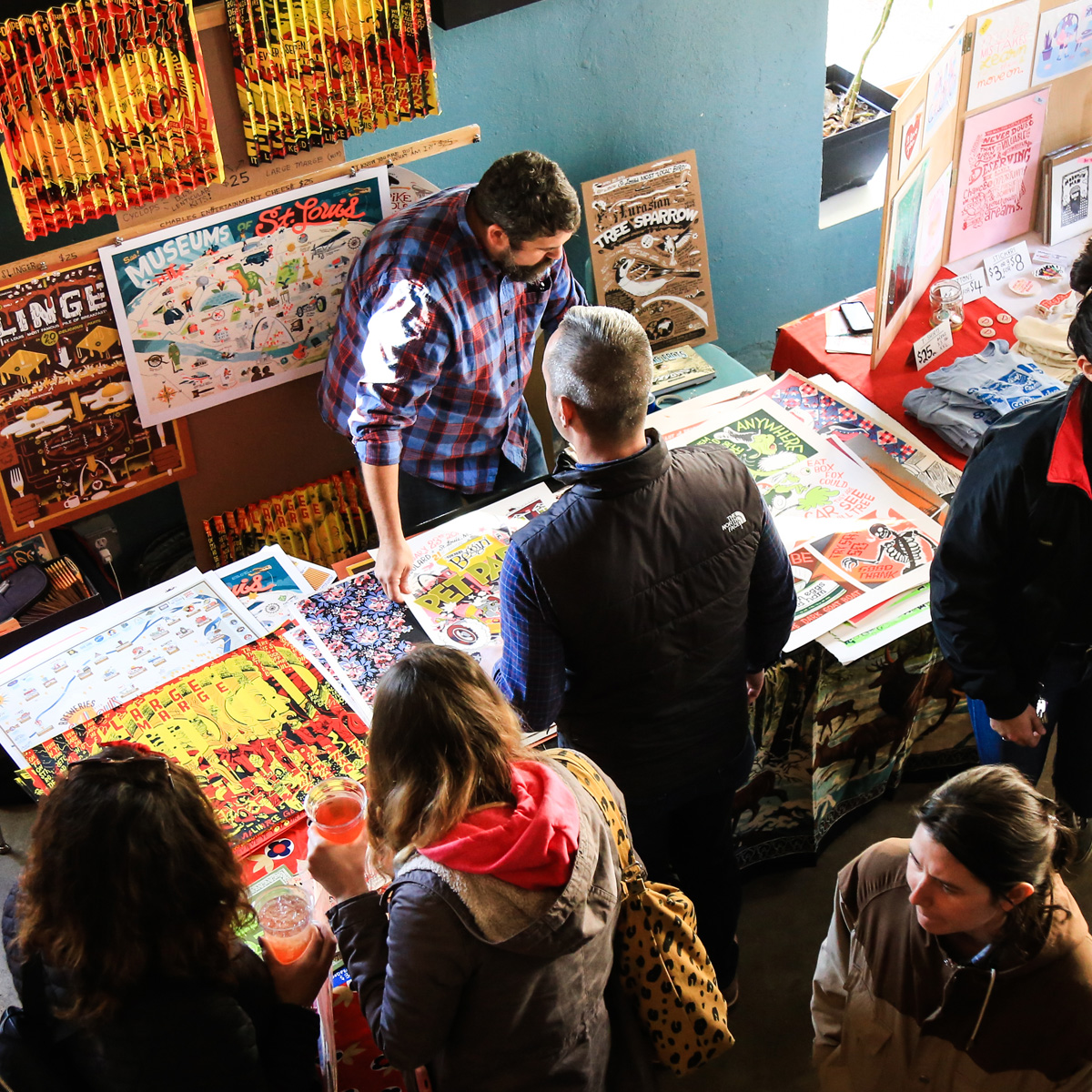 Man displaying his art to people